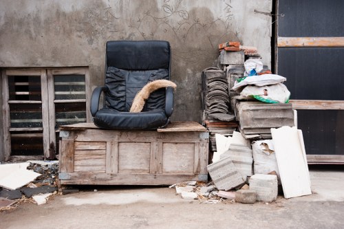 Customer loading waste into a skip in Norbiton