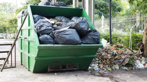 Workers sorting materials at a skip hire site in Norbiton